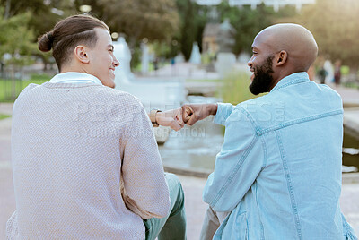 Buy stock photo Friends, students and men fist bump together on campus with smile, diversity and hope for future. Friendship, university and happy college people sitting outside, gen z man and friend with handshake.