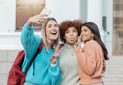 Buy stock photo Women students, selfie and peace with hug at college campus for goals, comic and social network. Gen z woman, group and smartphone with funny face, happiness and studying at university for success