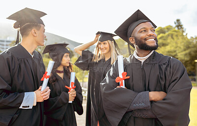 Buy stock photo Graduation, students and black man with friends at outdoor college celebration event. Happy graduate thinking of future, success and education goals with smile, dream and motivation of achievement 