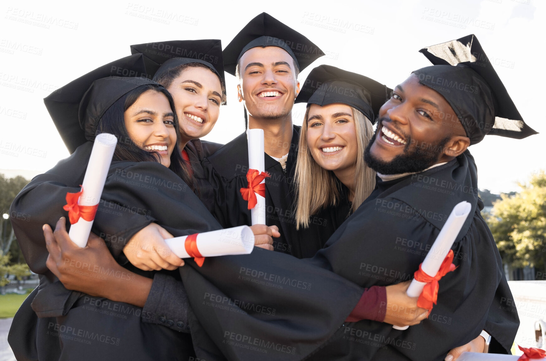 Buy stock photo Graduation, group portrait and hug for celebration, success and education event outdoor. Diversity, students and excited graduates celebrate at happy campus, university goals and college dream award