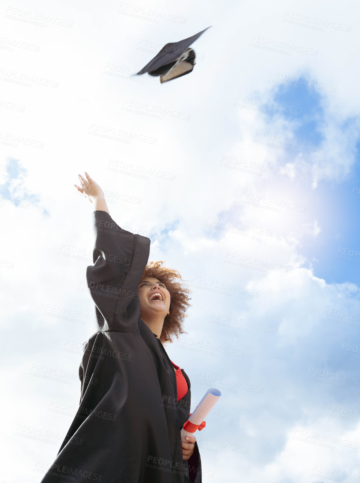 Buy stock photo Black woman, graduation and cap in air for celebration, happiness or success with diploma for studying at campus. University student, gen z girl and happy for goal, vision and achievement at academy