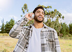 Music, happy and man relax in a park, smile and laughing at podcast or audio track against nature background. Earphones, laugh and handsome guy listening to online comedy, song or playlist in forest