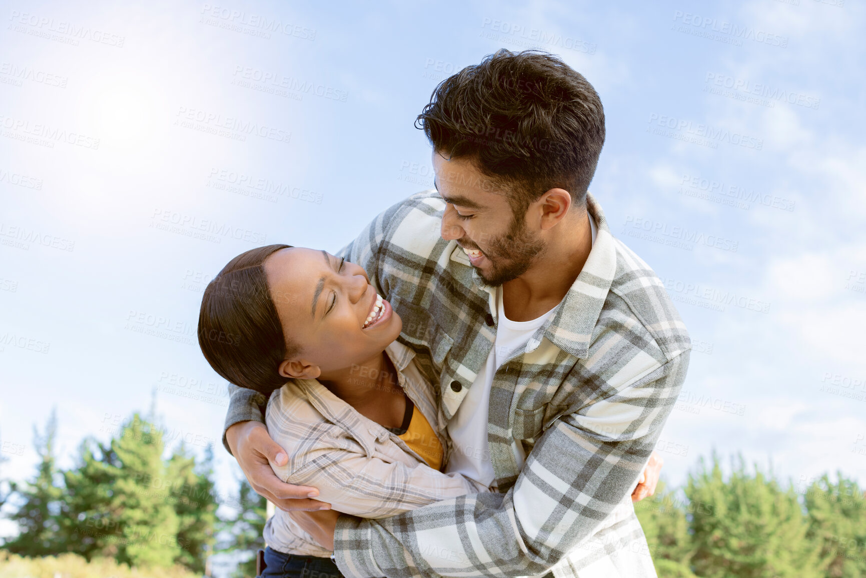 Buy stock photo Sky, diversity and nature couple hug on outdoor quality time together, hiking adventure or forest bonding journey. Peace, freedom and love for black woman, man or fun excited people trekking in woods