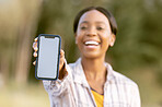 Mockup, smartphone and black woman in nature or park with happy portrait for mobile app or product placement. African person, hand holding phone and mock up screen, space and 5g technology in garden