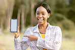 Mockup phone screen, smile and portrait black woman pointing at marketing or advertising content. Outdoor, technology and person point with happiness and online on mobile with blurred background 