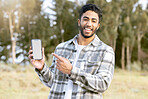 Mockup, phone and portrait of man in nature or forest with mobile app, product placement or 5g technology promotion. Happy person, hand holding smartphone and space, mock up and screen in a park