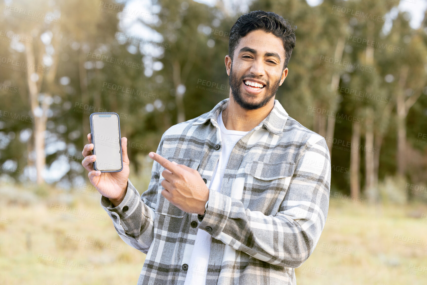 Buy stock photo Mockup, phone and portrait of man in nature or forest with mobile app, product placement or 5g technology promotion. Happy person, hand holding smartphone and space, mock up and screen in a park