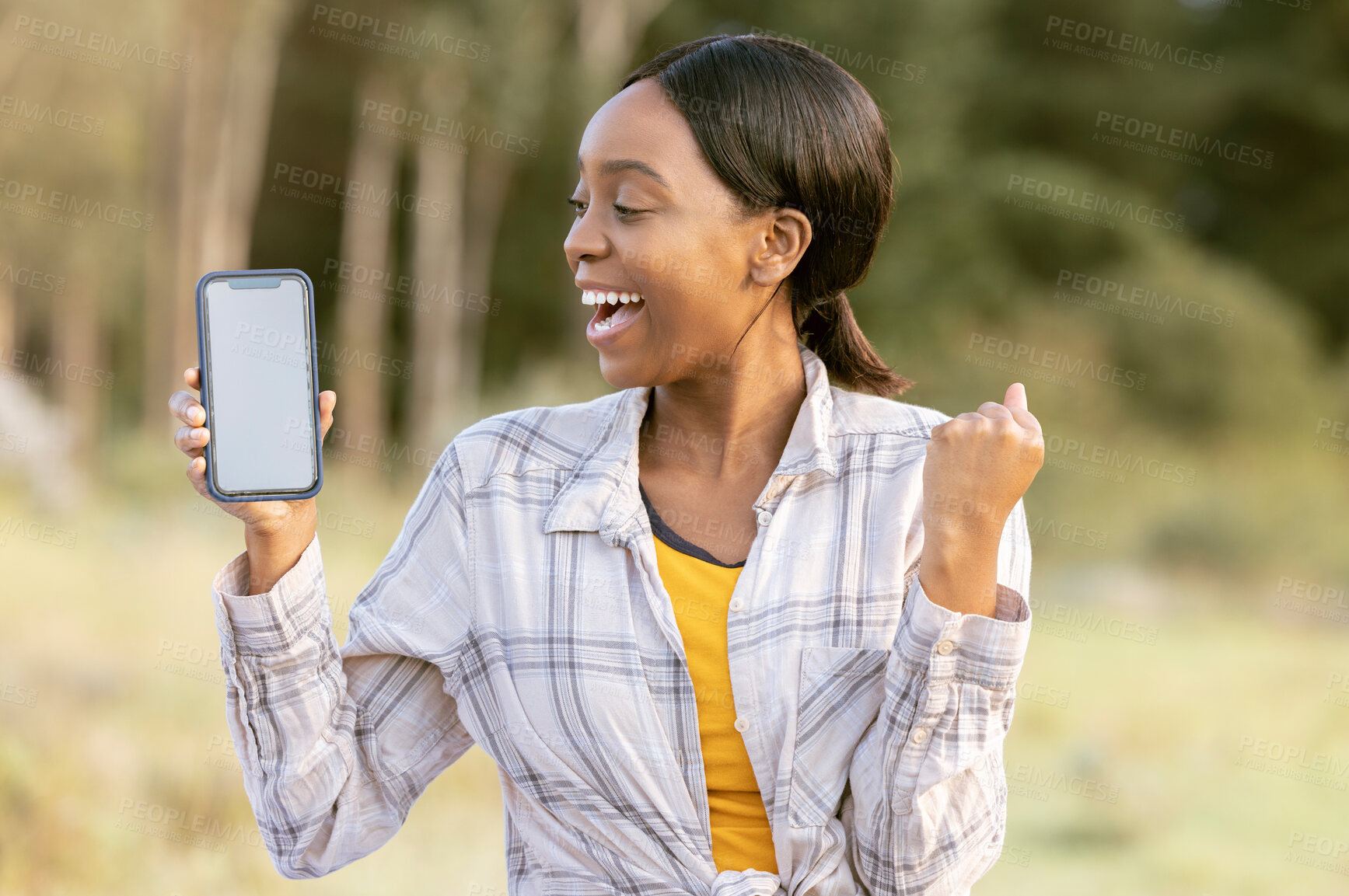 Buy stock photo Black woman, phone and mockup display for winning, discount or sale with smile in nature. Happy African American female smiling for giveaway prize, deal or achievement on smartphone in the outdoors