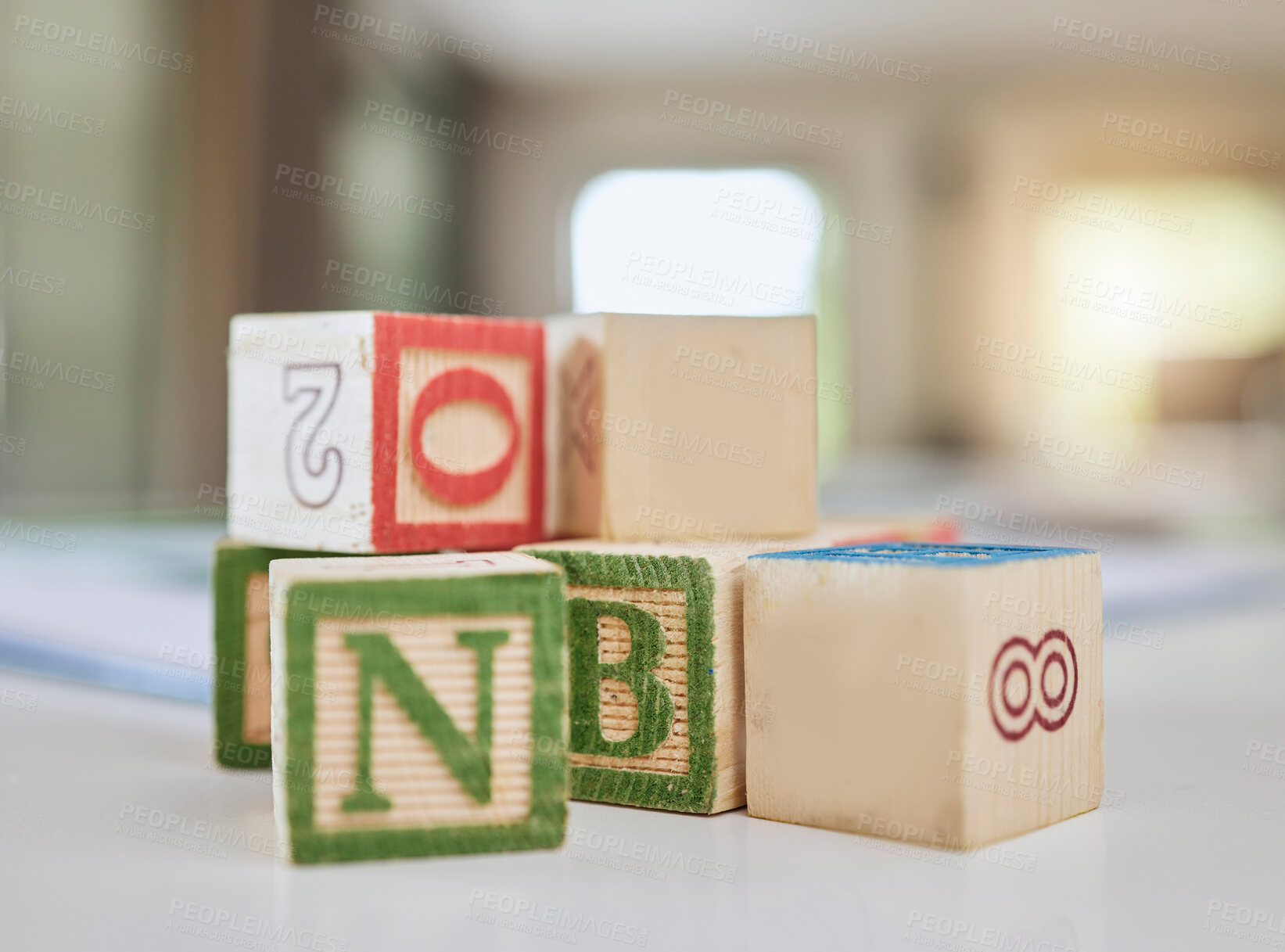 Buy stock photo Wooden blocks, table and letters for learning, education or childhood development at home. Colorful wood cube toys to learn numbers or alphabet for back to school, spelling or mathematics to read