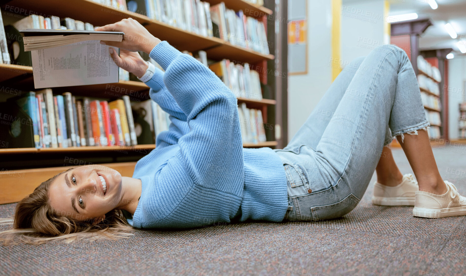 Buy stock photo Portrait, woman on floor and reading in library, relax and learning with smile, hobby or higher education. Female student girl or lady with book, knowledge or college research for studying and campus