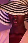 Fashion, model and black woman in neon light, UV and purple studio background wearing a sun hat. Style, makeup and beauty by female with dark skin aesthetic creativity and color design
