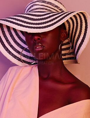 Buy stock photo Model, design and black woman fashion in neon, UV and purple light in studio background wearing a sun hat. Style, makeup and beauty by female with dark skin aesthetic creativity and color
