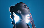 Woman, beauty and profile of a model thinking in a studio with cosmetics and makeup. Young person, face hand touch and zen female with lighting and blue background isolated feeling relax and calm