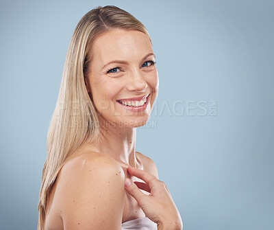 Buy stock photo Portrait, beauty and mockup with a model woman in studio on a gray background for skincare treatment. Face, skin and mock up with an attractive young female posing to promote natural cosmetics