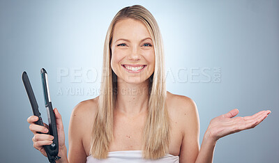 Buy stock photo Face portrait, hair straightener and woman in studio with product placement isolated on a gray background. Beauty, haircare and female model advertising or marketing flat iron for salon treatment.