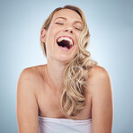 Beauty, skincare and laughing with a model woman in studio on a gray background enjoying a joke or humor. Facial, cosmetics and funny with an attractive young female joking for natural treatment