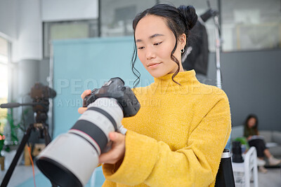 Buy stock photo Photography camera, asian woman and digital agency worker review pictures in a studio. Photographer, production process and professional photoshoot with a creative employee checking catalog results