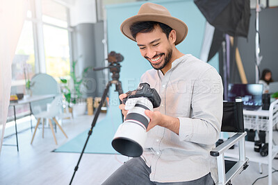 Buy stock photo Happy, photographer and man with camera in studio, smile and excited before a photo shoot. Backstage, photography and asian guy relax during profession, shooting for design and creative career