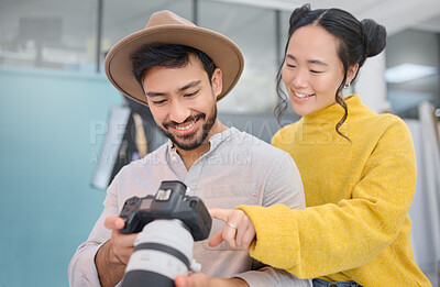 Buy stock photo Creativity, photographer and woman in discussion with a camera choosing a image from photoshoot. Photography, art and young cameraman talking to a model to choose the best picture in creative studio.