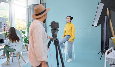 Buy stock photo Photographer, shoot and woman model in studio for professional, photo and posing on wall background. Photography, magazine and man taking pictures of asian girl on mockup, creative and contemporary 