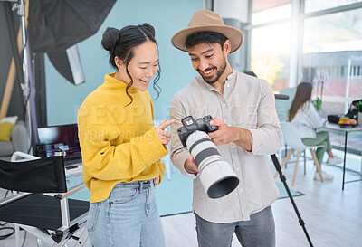 Buy stock photo Camera, creativity and photographer talking to a model while looking at pictures from a photoshoot. Photography, creative and young cameraman choosing a image with a woman in creative artistic studio