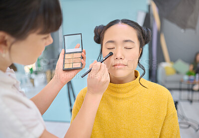 Buy stock photo Makeup, artist and woman in studio with professional, cosmetics and creative, product and glamour. Asian, face and model with artistic makeover specialist, backstage for beauty, eyeshadow or contour