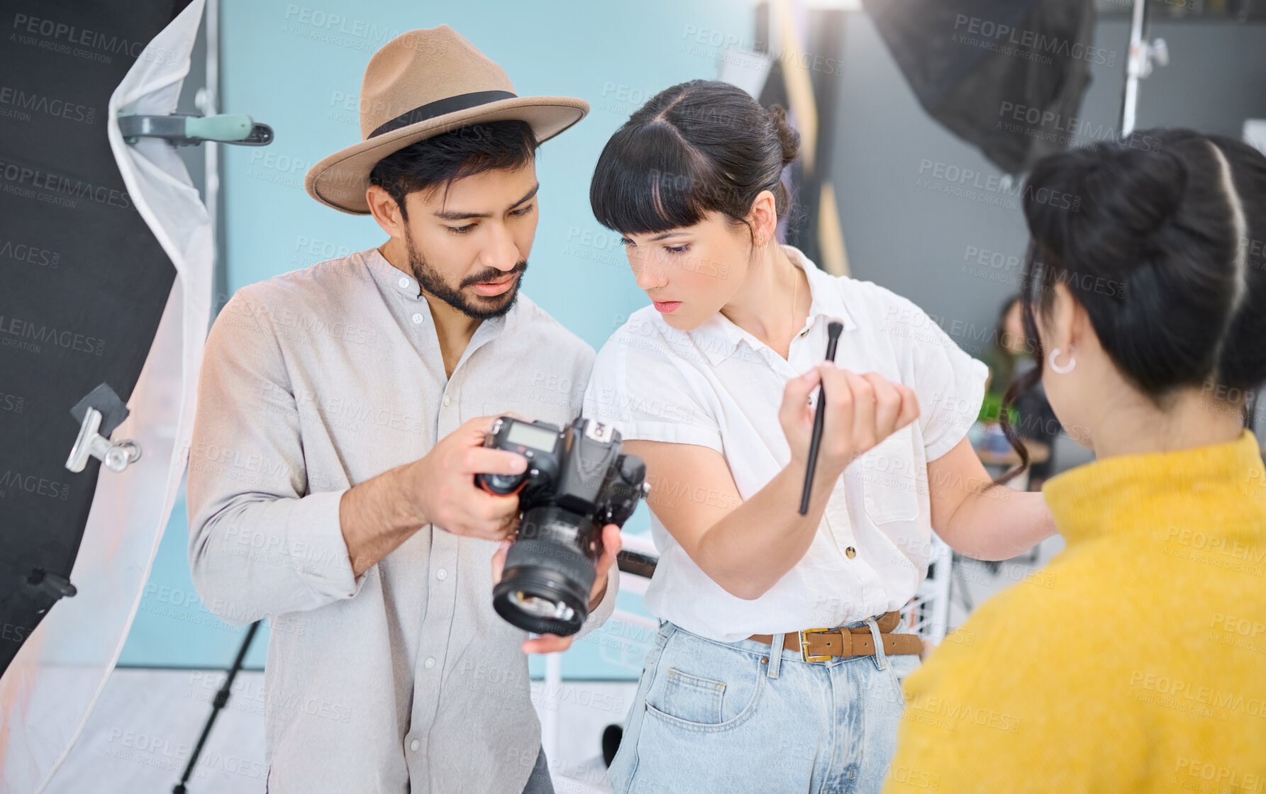 Buy stock photo Makeup artist, photographer and model checking pictures during artistic, process and glamour shooting in studio. Man, photography and lady coworking on creative, project and magazine cover together