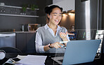 Laptop, futuristic hologram and woman in home kitchen  laugh at funny meme. Freelancer, remote worker and Asian female pointing to computer with 3d, augmented reality or data graphs at night in house
