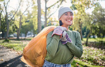 Plastic bag, park and woman cleaning in eco friendly, climate change or community service project for volunteering. Garbage, recycle and nonprofit or ngo person smile in nature forest for pollution