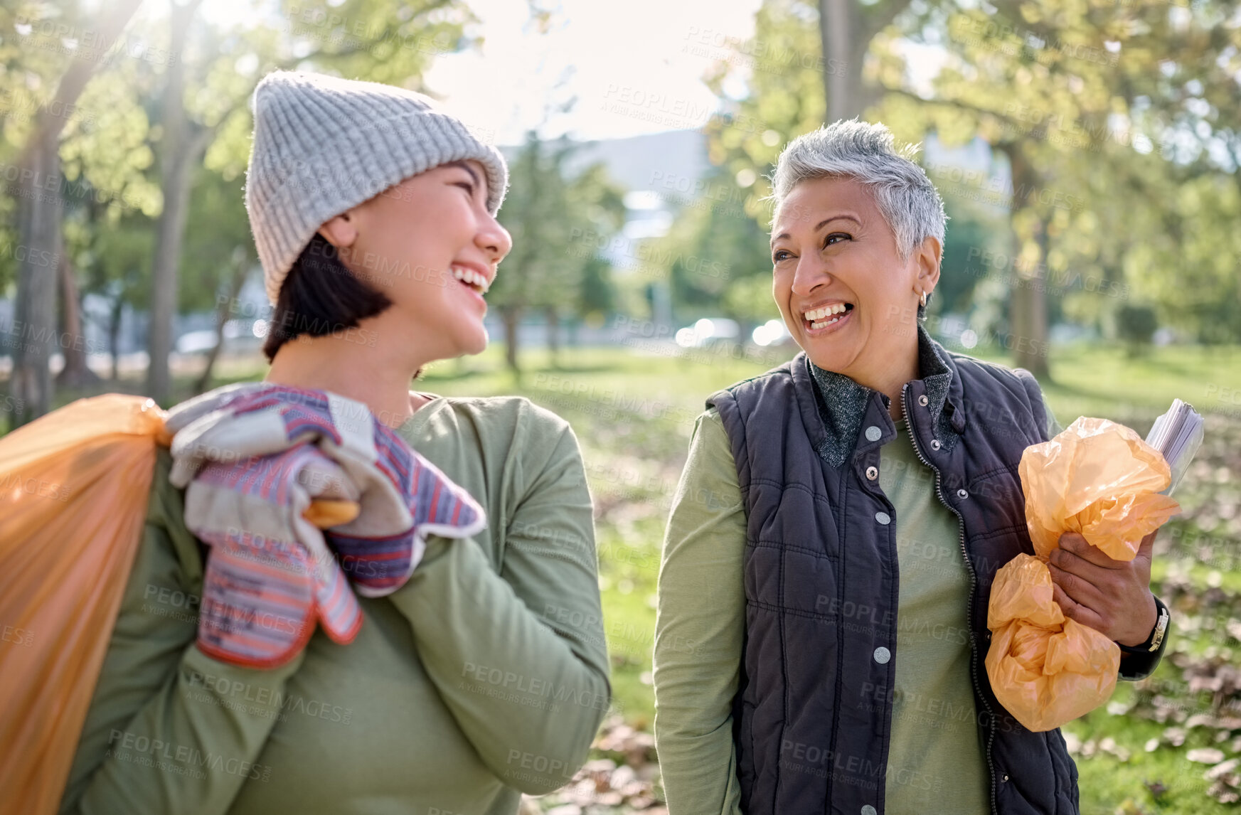 Buy stock photo Cleaning, plastic bag and people in park for community service, volunteering and pollution help, support and goals. Happy senior woman with youth in nature or forest with waste, garbage or recycling