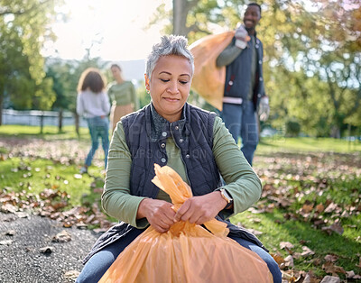 Buy stock photo Trash, volunteer and senior woman cleaning garbage, pollution or waste product for environment support. Plastic bag, eco friendly community service and NGO charity team help with nature park clean up