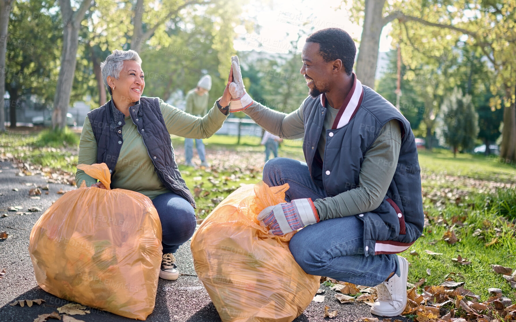 Buy stock photo High five, volunteer or team celebrate cleaning garbage pollution, waste product or environment support. Plastic bag container, NGO charity help or eco friendly community done with nature clean up