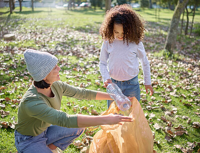 Buy stock photo Trash, volunteer woman and child cleaning garbage, pollution or waste product for community environment support. Plastic bag container, NGO charity and eco friendly kid help with nature park clean up