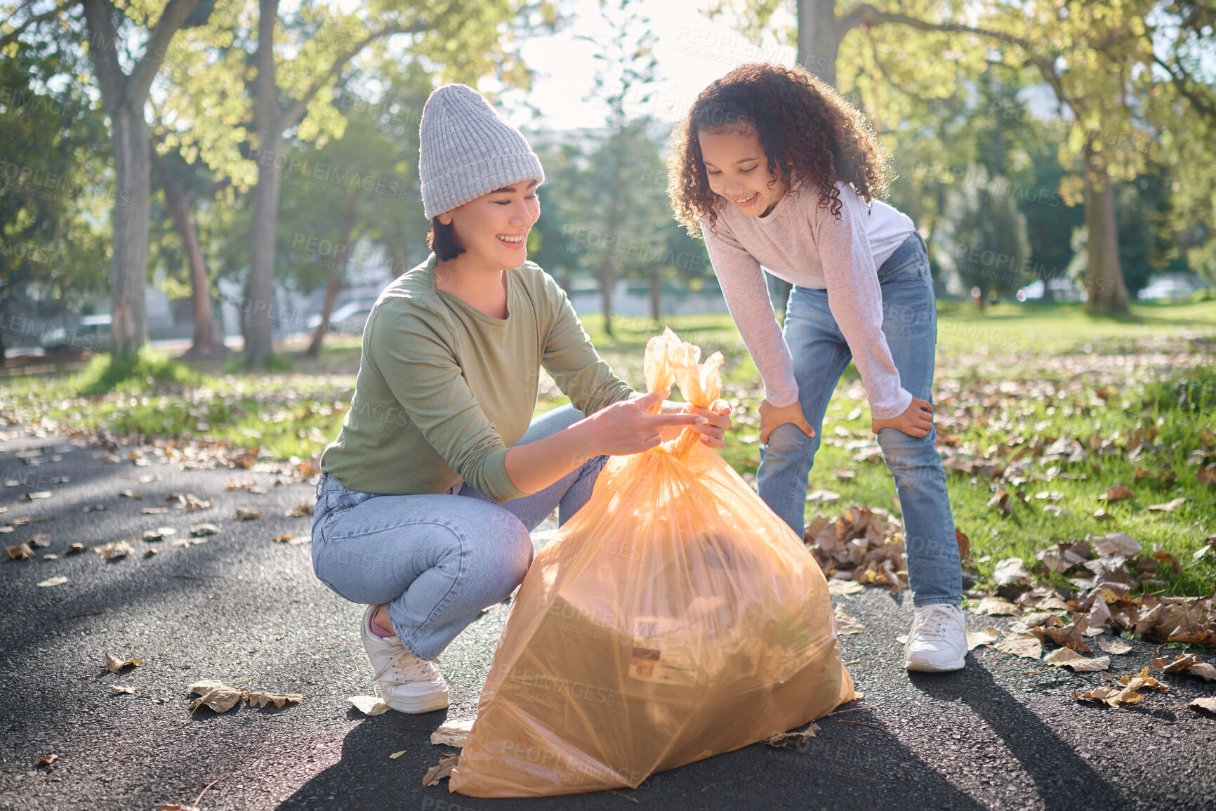 Buy stock photo Trash, volunteer woman and kid cleaning garbage, pollution or waste product for environment community service. Plastic bag container, NGO charity and eco friendly child help with nature park clean up