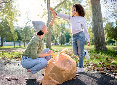 Buy stock photo High five, volunteer woman and kid cleaning garbage pollution, waste product or community environment support. Teamwork celebration, NGO charity and eco friendly child done with nature park clean up