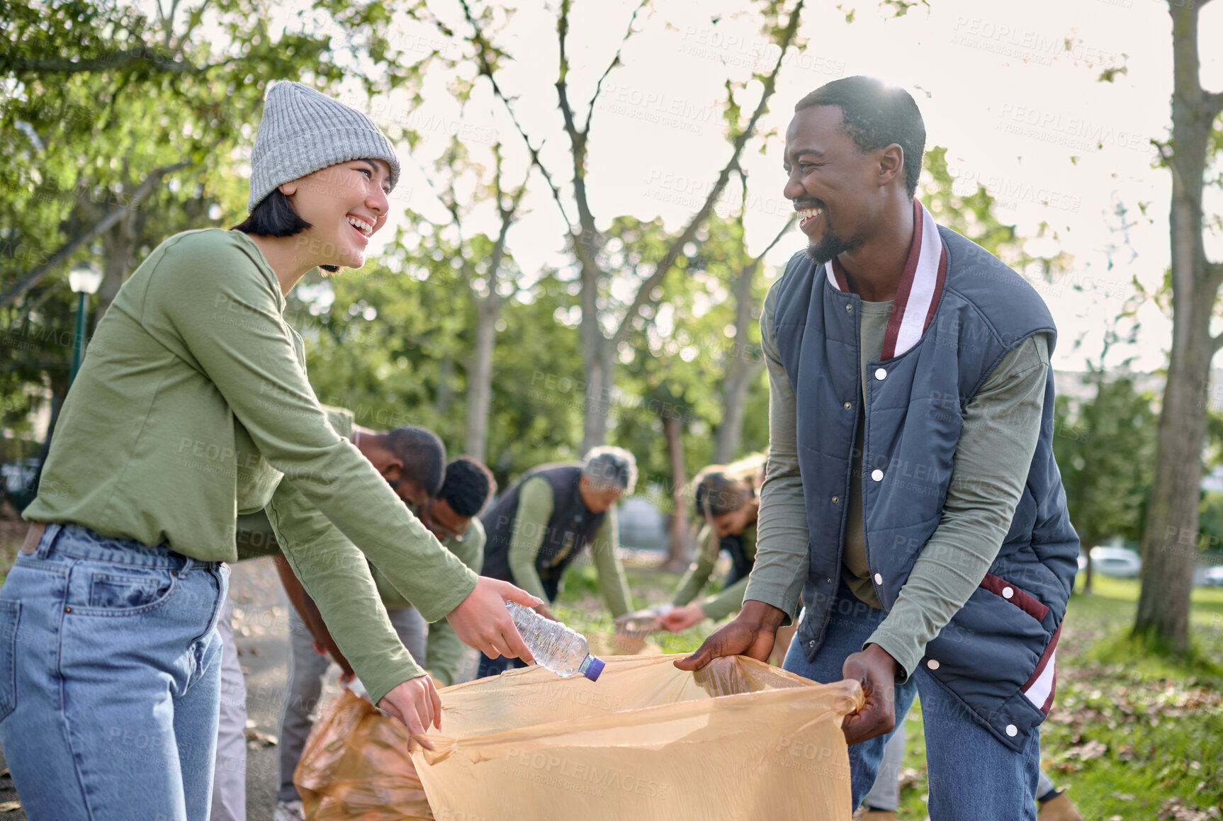 Buy stock photo Community volunteer, teamwork and cleaning park of plastic with garbage bag for a clean environment. Diversity man and woman help with trash for eco friendly lifestyle and recycling outdoor in nature