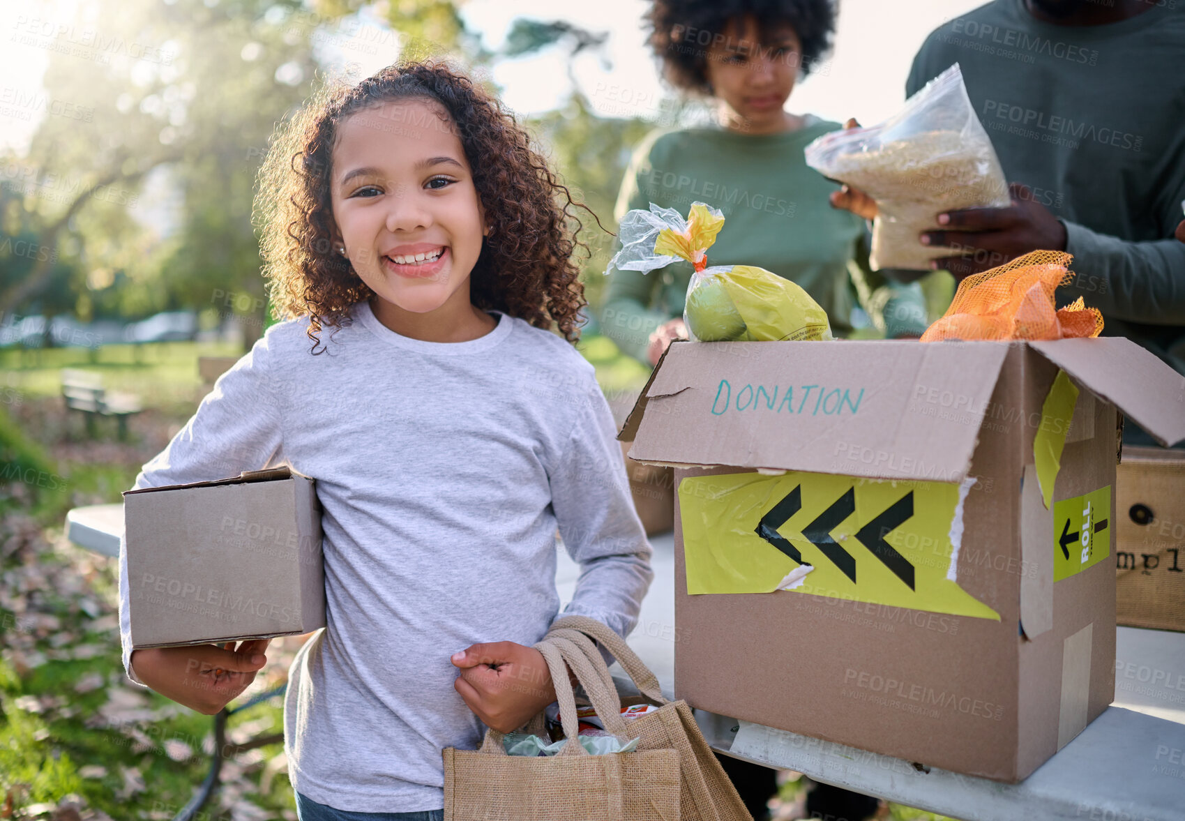 Buy stock photo Food, donation and portrait of child in park with smile and grocery box, healthy diet at refugee feeding project. Girl, charity and donations help feed children and support from farm volunteer at ngo