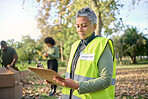 Volunteer, clipboard and senior woman with checklist in park for charity, planning and organized donation. Community, service and elderly lady checking list in forest for environment, help or project