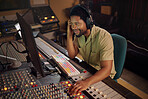 Computer, music and male producer in studio working on a album, song or audio with tech equipment. Happy, smile and black man radio presenter playing a playlist with technology in creative workplace.