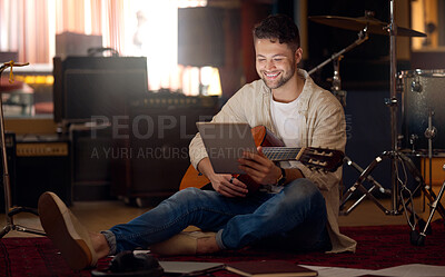 Buy stock photo Digital tablet, guitar and man in a recording studio for music production or acoustic performance. Musician, artist and happy male guitarist on a mobile device with a musical string instrument.