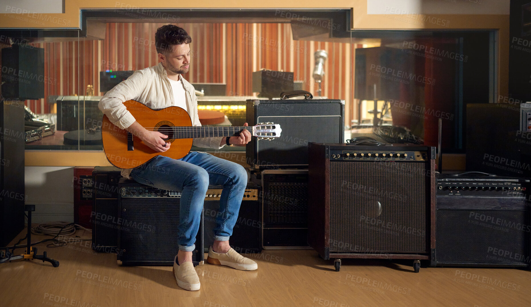 Buy stock photo Recording studio, acoustic and man playing the guitar for music production or practicing for a performance. Artist, guitarist and guy strumming the strings of a musical instrument for a sound track.