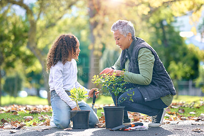 Buy stock photo Woman, child and plant while gardening in a park with trees in nature, agriculture or garden. Volunteer team planting for growth, ecology and sustainability for community environment on Earth day