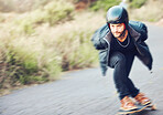 Skateboard, sports and man skating on road for fitness, exercise or wellness. Training, freedom and male skater moving with fast speed, skateboarding and riding alone outdoors for action or workout.