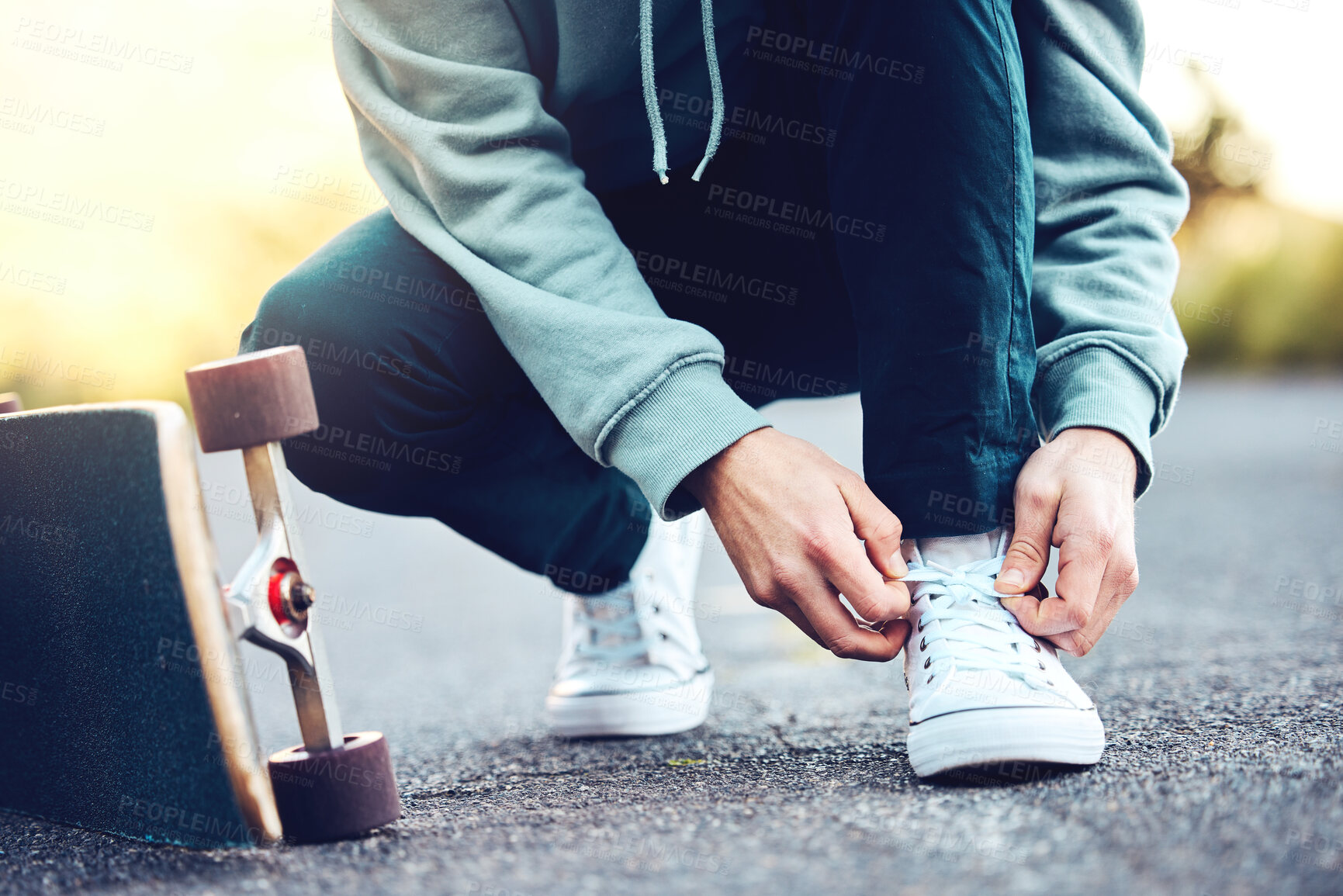 Buy stock photo Hands, skater and man tie shoes on street to start fitness, training or workout. Sports, skateboarding and male with skateboard, tying sneaker laces on road and getting ready for exercise outdoors.