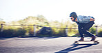 Sports, skateboard and man riding on road for fitness, exercise and wellness. Training, freedom and male skater on board moving with fast speed, skateboarding and skating outdoors for action workout
