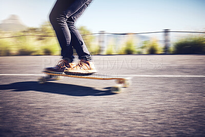 Fast, blur and legs of a man on a skateboard in street for exercise, training and travel in Australia. Fitness, sports and legs of a person skateboarding in the city road for fun, speed and cardio