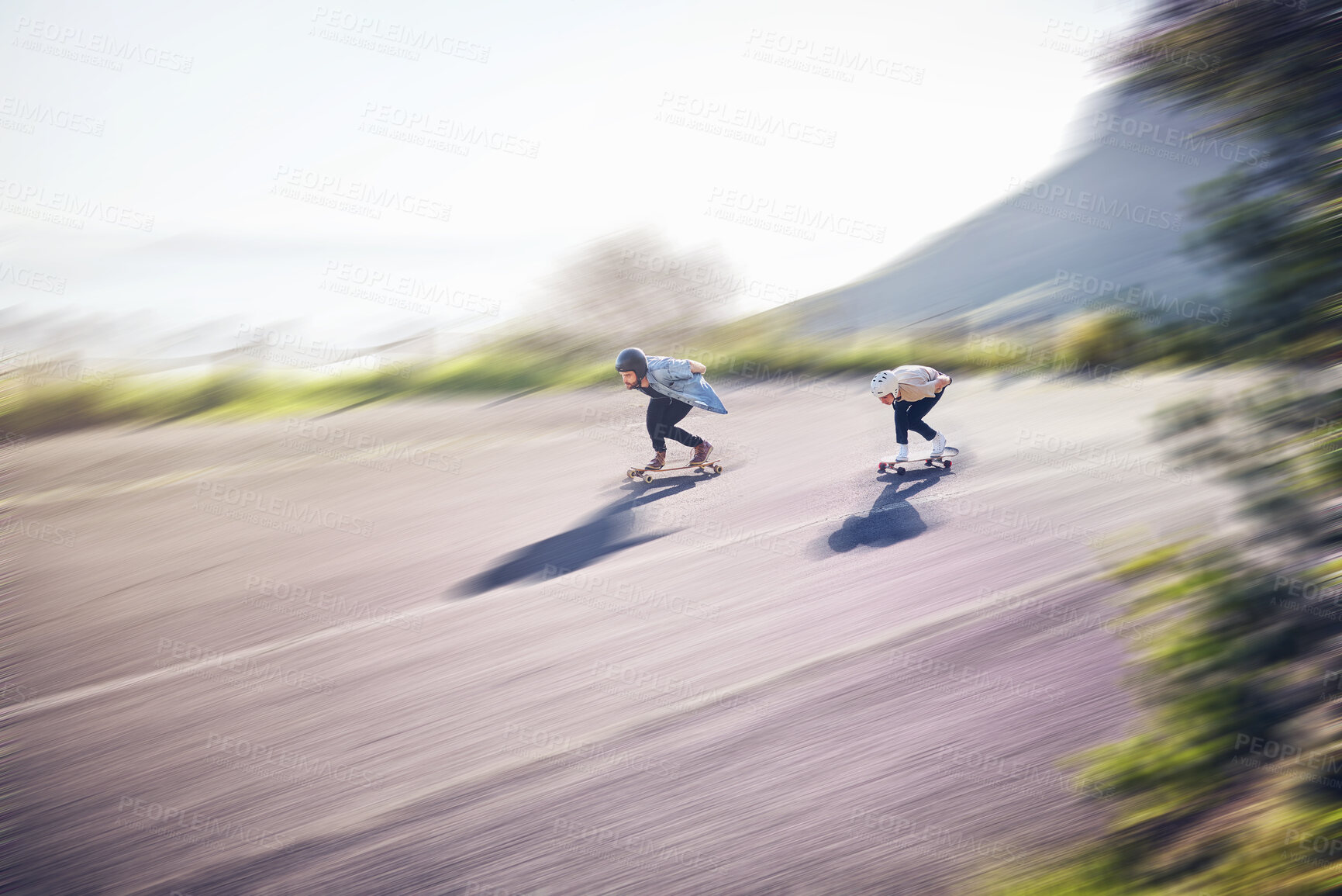 Buy stock photo Skateboard, fast and people on road training, competition or danger, risk and adventure sports, above. Speed, blurred background and skater team moving on street for youth energy, balance and action