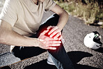 Hands of man, knee pain and skateboarder with injury after fall, accident or workout outdoors. Sports, fitness and male skater with fibromyalgia, arthritis or leg inflammation after skating exercise.