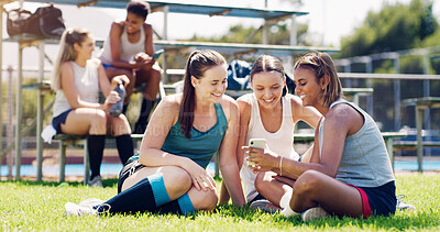 Buy stock photo Sports, women and group outdoor, smartphone and connection with girls on field, chatting and relax. Fitness, female athletes smile and young ladies with cellphone, summer and on break after training