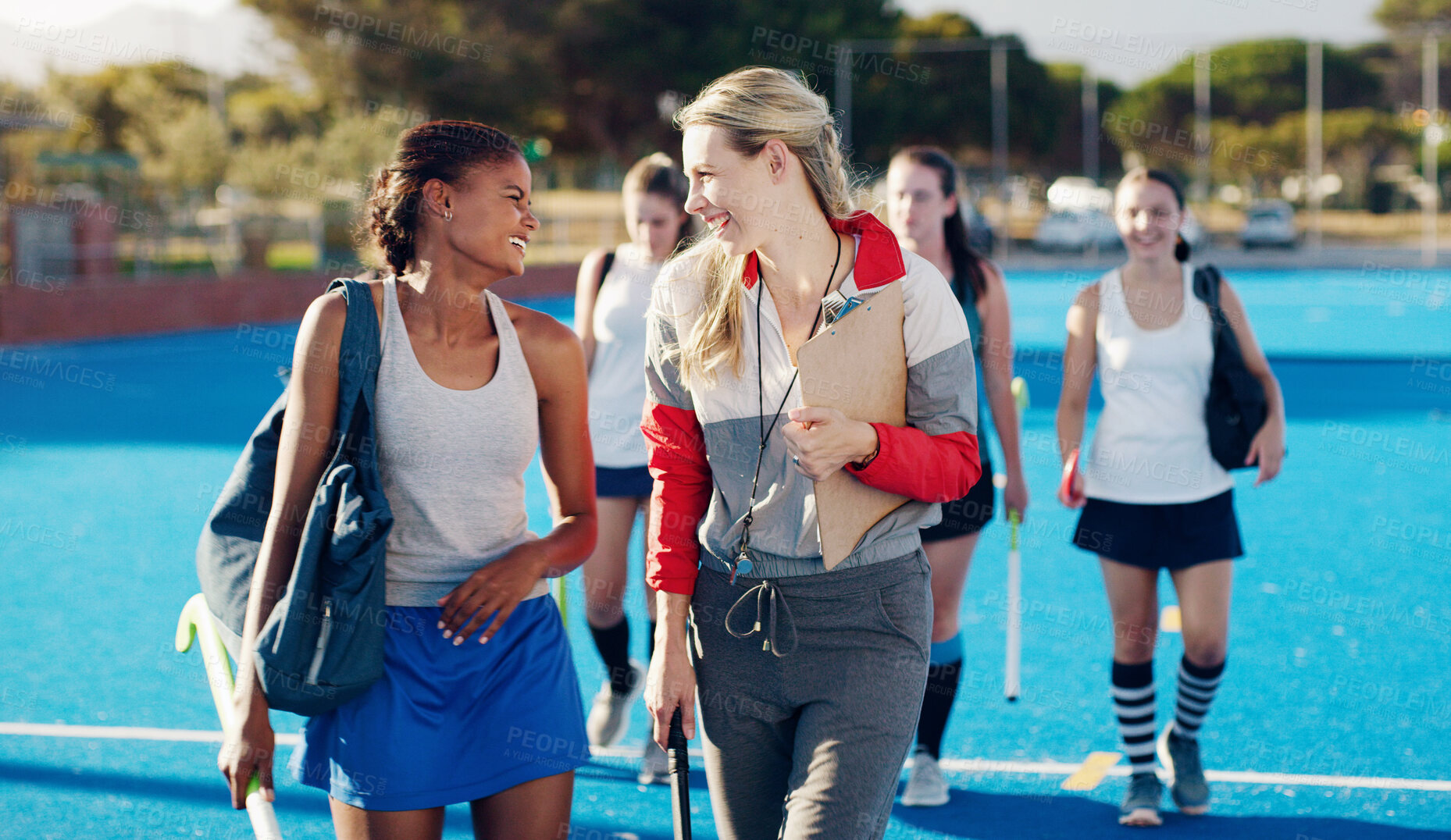 Buy stock photo Team leader, hockey and happy discussion with player for coaching, teamwork or collaboration in the outdoors. Fitness sporting coach talking with athlete in friendly conversation for training tips